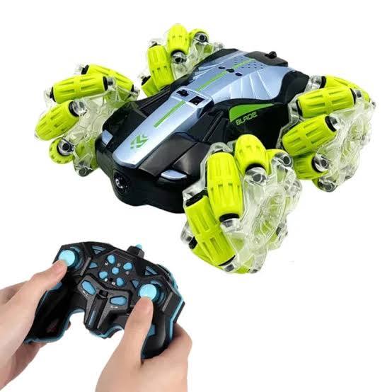 Toy blaster with green and black design held by a hand available at Juniors Toys