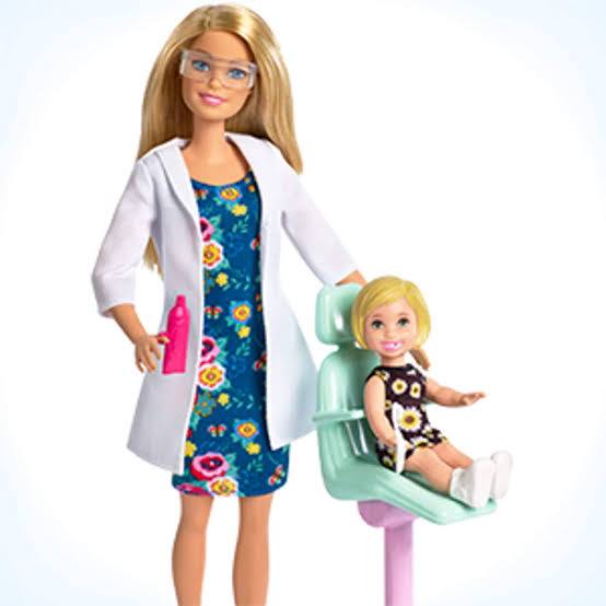 Barbie doll in a doctor's outfit with a patient in a chair on a white available at Juniors Toys