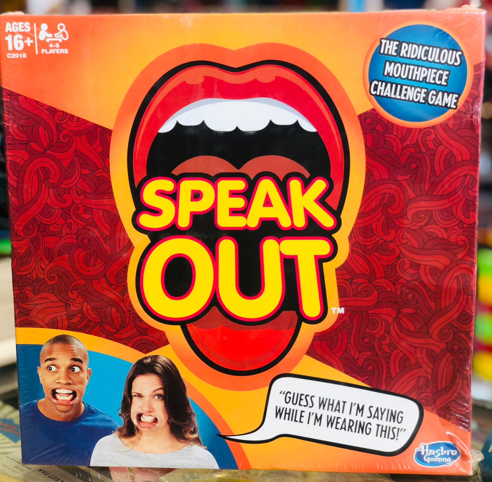 Board game box for 'Speak Out' with a mouth graphic and two people's faces on a colorful background availble at Juniors Toys