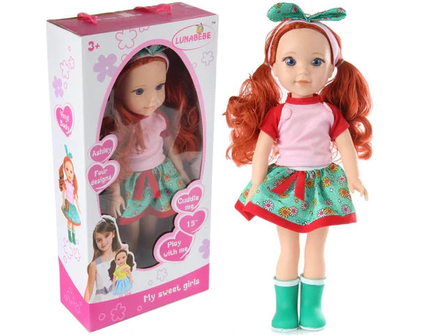 Doll with red hair and green shoes next to its packaging available at Juniors Toys