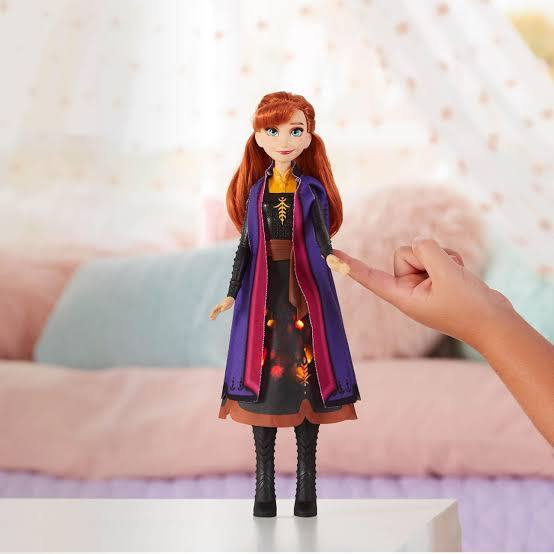 Toy figure of a character from a popular franchise held by a hand against a soft, blurred background Princess Anna Doll at Juniors Toys