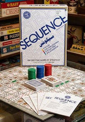 Sequence board game packaging with components on a table available at Juniors Toys