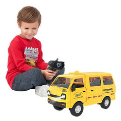 Child playing with a yellow toy van and remote control on a white background available at Juniors Toys
