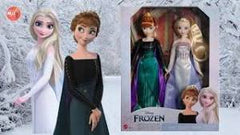 Two dolls from 'Frozen' in packaging with a snowy background - Disney Frozen Elsa and Anna Dolls Set at Juniors Toys
