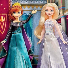 Two dolls, one with red hair and the other with blonde hair, standing in front of a colorful background - Disney Frozen Elsa and Anna Dolls Set at Juniors Toys