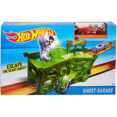 An open Hot Wheels Ghost Garage playset featuring a purple slime creature and Hot Wheels cars on a display table next to its box available at Juniors Toys