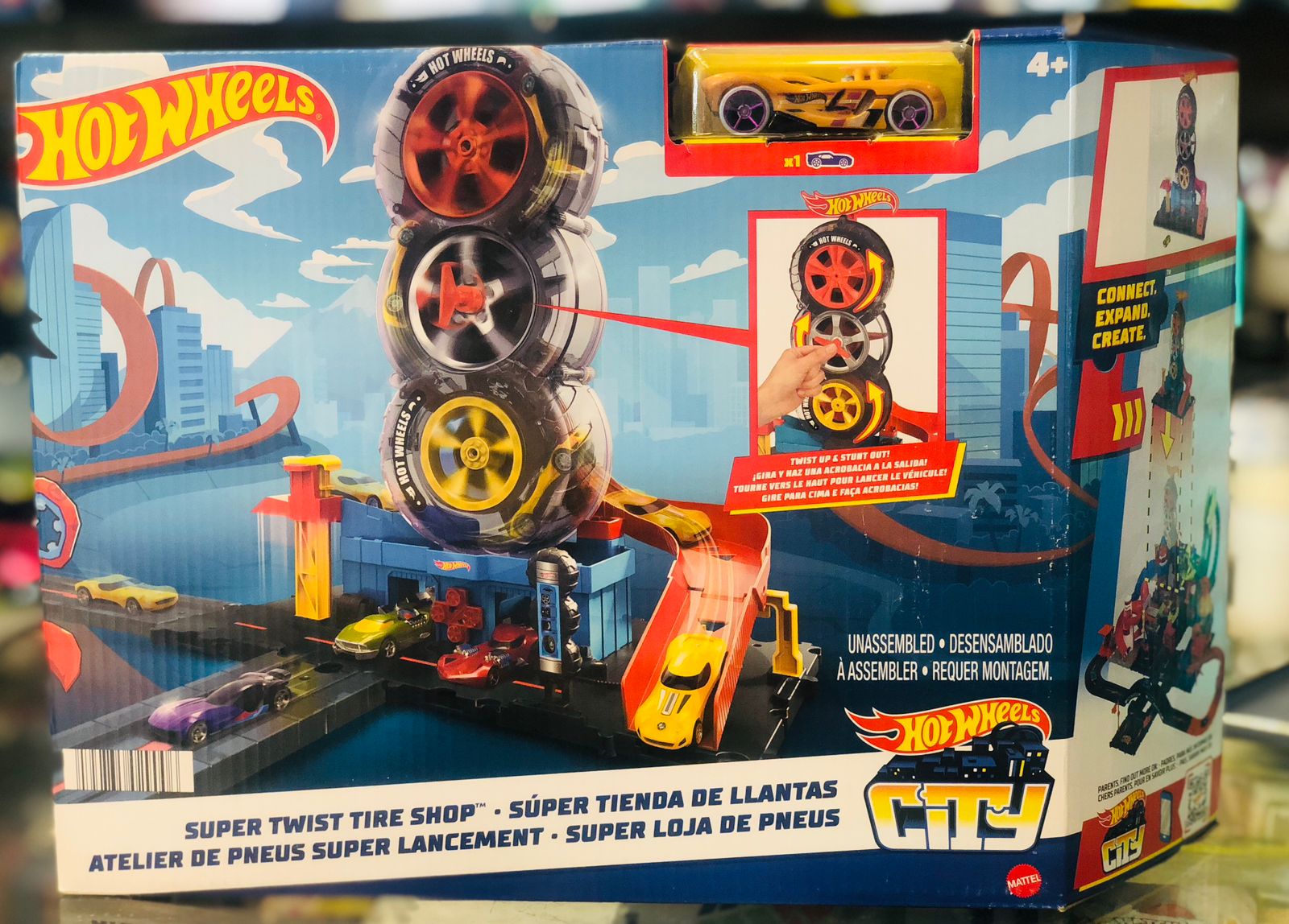 Hot Wheels City Super Twist Tire Shop toy set packaging with toy cars and track available at Juniors Toys