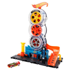 Detailed packaging of the Hot Wheels Super Twist Tire Shop with a yellow die-cast car included available at Juniors Toys