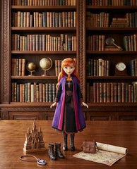 Doll with red hair and purple cloak standing in front of a bookshelf - Princess Anna Doll at Juniors Toys