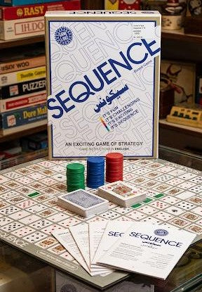 Sequence board game packaging with components on a table available at Juniors Toys